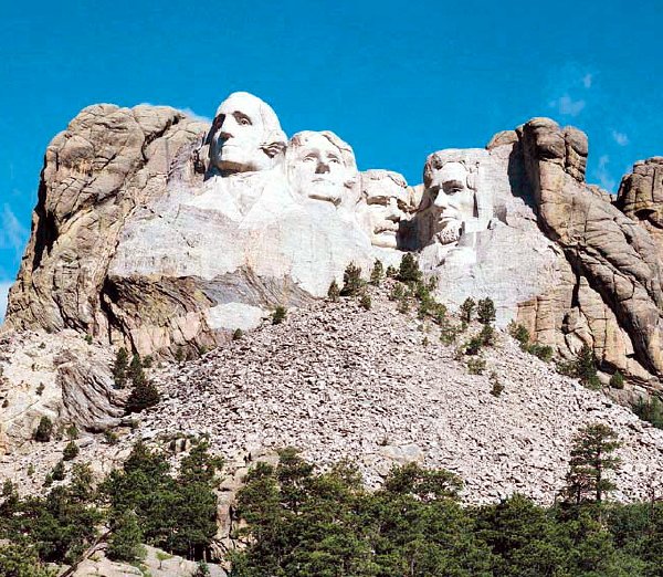 Mount Rushmore featuring iconic U.S. presidents, with a focus on the connection to land surveying history.