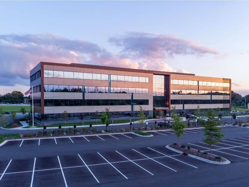 Alta table a item 8 parking lot | ALTA Land Survey Commercial office building with a marked parking lot and landscaped islands, illustrating substantial features under ALTA Table A Item 8