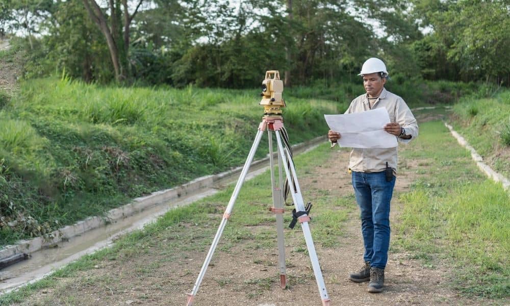 Land surveyor reviewing property plans | ALTA Land Survey Land surveyor reviewing property plans for an ALTA Table A Item 21 request