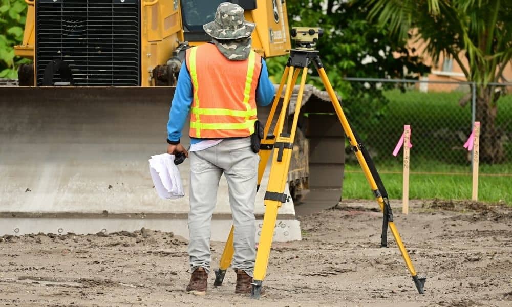 Alta survey commercial development site | ALTA Land Survey Surveyor using a total station on a commercial development site for an ALTA survey